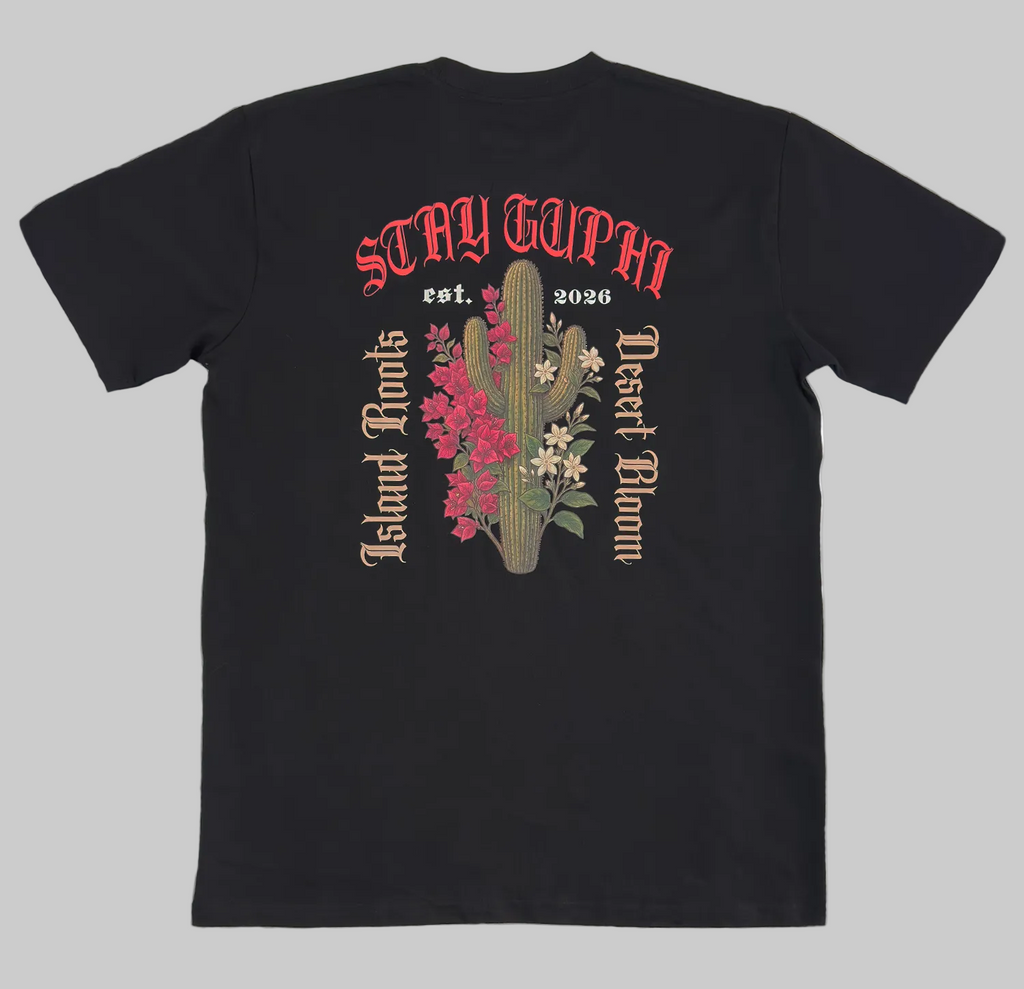 The back of the Cactus Bloom Classic Tee in Black, showing the cactus and island floral design with old style text around it. Island Roots, Desert Bloom, Stay GUPHI.