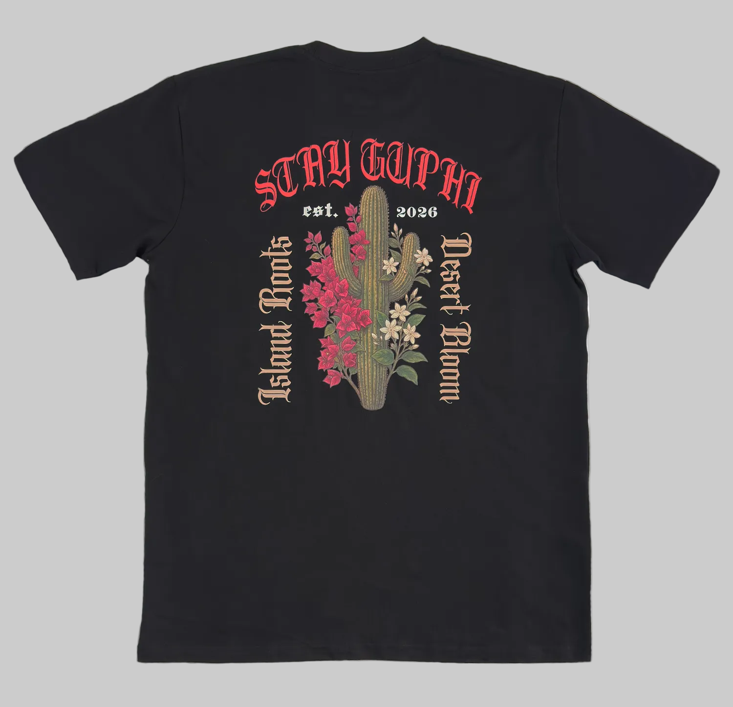 The back of the Cactus Bloom Classic Tee in Black, showing the cactus and island floral design with old style text around it. Island Roots, Desert Bloom, Stay GUPHI.